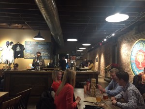Several customers play Jenga while sipping on their Urban Chestnut brews. The brewpub often offers live entertainment and games to customers while they drink.