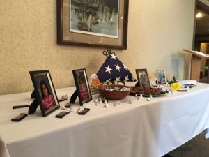 The centerpiece of the wake, which featured a traditional tri-fold American flag, pictures of Barnes' husband and grand-children, and chocolates for visitors.