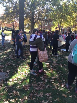 Two students emotionally embrace one another, one moved to tears, during the Dump Trump rally on the quad. 