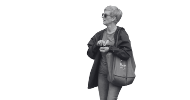 Sue Thomas holding a Truman State University Tote bag.